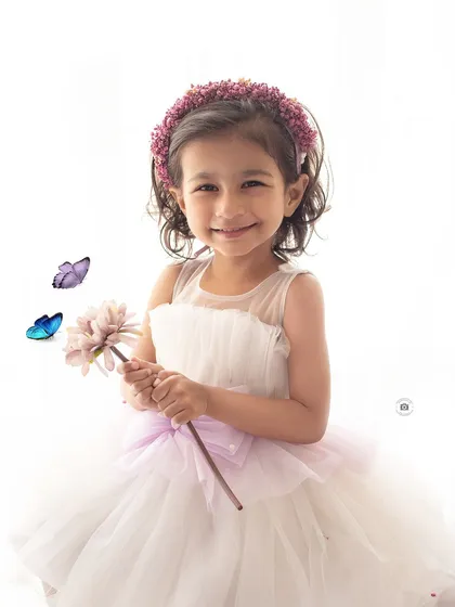 A bright and airy portrait with a beautiful, genuine smile. The high-key lighting creates a soft and angelic feel.