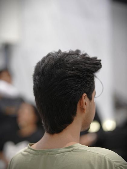 The back view of this men's haircut shows the clean tapering and texture on top.