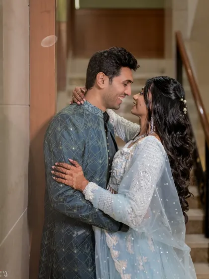 A sweet, candid moment between the couple on the stairs. Their smiles and eye contact show their genuine connection, and we capture it in a way that feels unposed and natural.