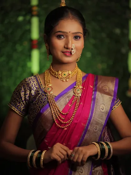 A classic portrait of a Maharashtrian bride. Her simple smile and confident posture show how comfortable and beautiful she feels in her traditional attire and makeup.