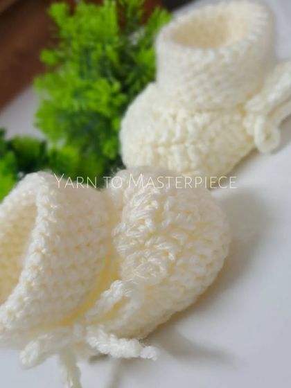 Simple, classic, and incredibly soft, these off-white crochet booties are a versatile choice for any special occasion. The tie closure ensures a snug fit.