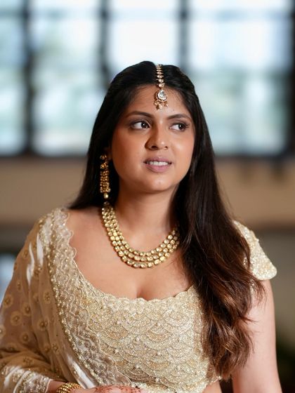 A beautiful portrait capturing the essence of "less is more." The makeup is natural and soft, perfect for a sophisticated wedding guest.