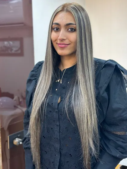 A stunning ash highlights transformation on very long, straight hair. The cool tones create a sleek and sophisticated look.