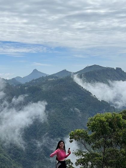 A trekker enjoying the panoramic view from a viewpoint in Kodaikanal.