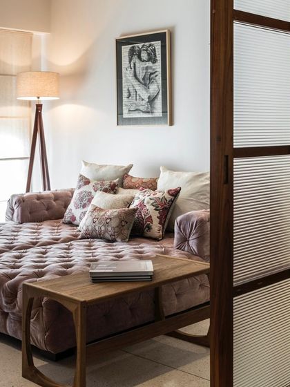 Another view of the cozy den in the Terrazzo Residence, showing the fluted glass sliding door that separates it from the main living area.