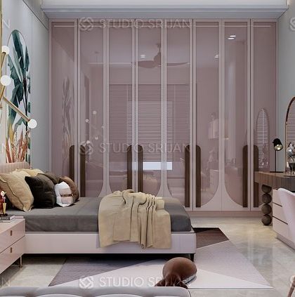 The wardrobe in this bedroom features custom, curved handles and a glossy pink finish, adding to the room's chic and playful character.