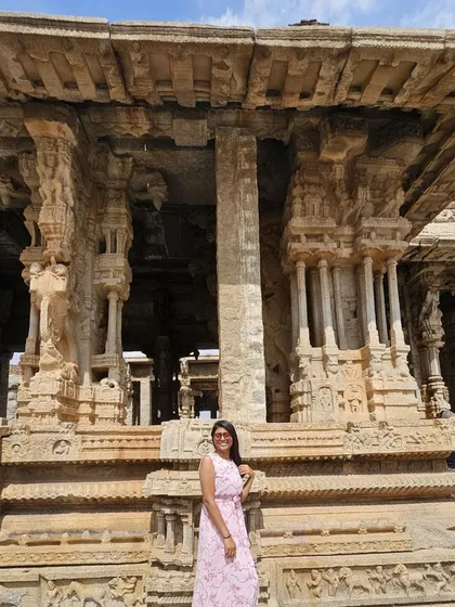 Posing in front of the musical pillars at the Vittala Temple in Hampi.