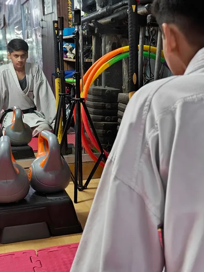 A student in a moment of quiet contemplation before training. We teach our students to find focus and confidence from within.