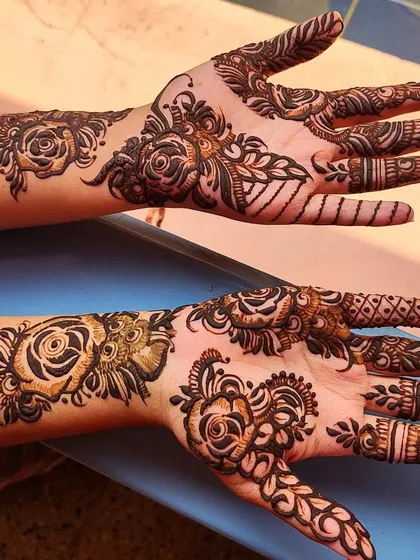 A party henna design featuring a mix of different rose styles, from buds to fully bloomed flowers.