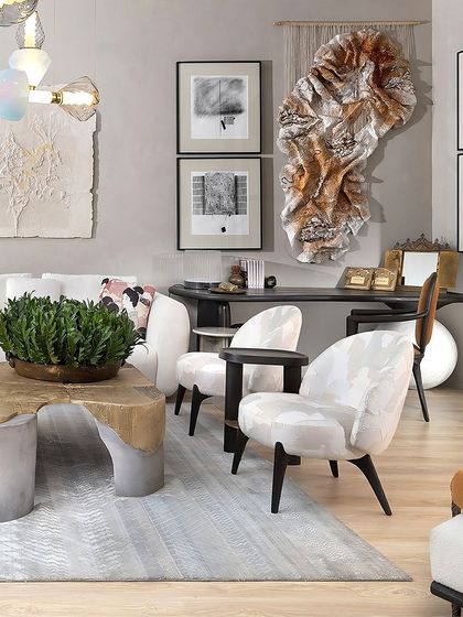 Our Koko furniture is a symphony of beautiful form and superb functionality. This space features our luxuriously upholstered lounge chairs with solid teakwood legs, paired with a side table that combines an oak wood top with a practical brass tray.