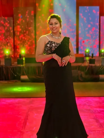 A confident stance on stage before the Sangeet performances begin. Ready to bring the glamour and energy.