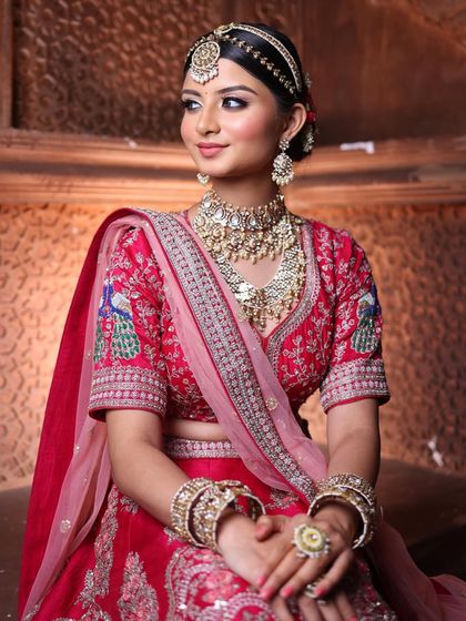 This look captures the essence of a royal bride. The makeup is kept sophisticated and clean to balance the grandeur of the jewellery and the richly embroidered lehenga.