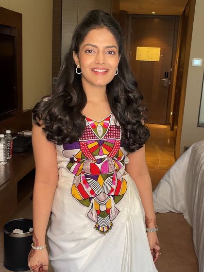 The client looking happy and radiant with her voluminous hairstyle.