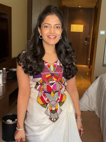 The client looking happy and radiant with her voluminous hairstyle.