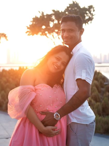 The magic of golden hour is undeniable. This warm, sun-drenched portrait of a couple embracing captures the love and glow of this special time against a beautiful waterfront backdrop.