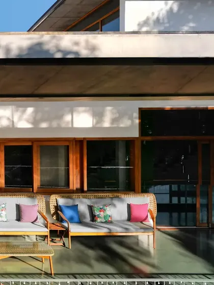 The outdoor seating area on the upper balcony, a perfect spot to enjoy the garden views under the protection of the roof.
