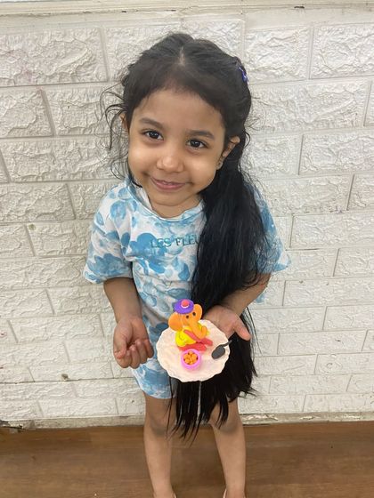 A close-up of a tiny, colorful Ganesha idol crafted with care by one of our youngest students.