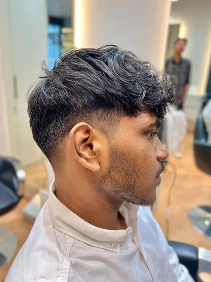 Tapping into the chaos with an edgy and daring messy taper fade haircut.