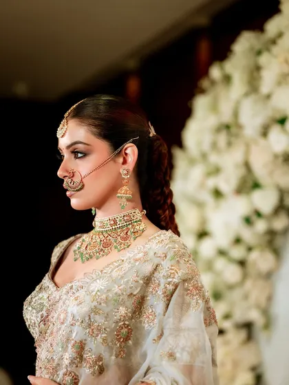 This side profile highlights the hairstyle and the way the makeup complements the intricate jewelry. We explore how to balance different elements for a harmonious and elegant result.