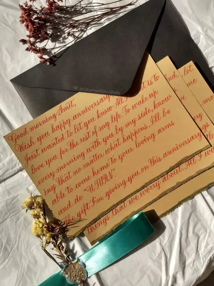 An anniversary letter is a beautiful way to capture your feelings. For this piece, I used a vibrant red ink on textured, deckled-edge paper, rolled and tied with a silk ribbon and a wax seal. It’s a complete gift, ready to be cherished.
