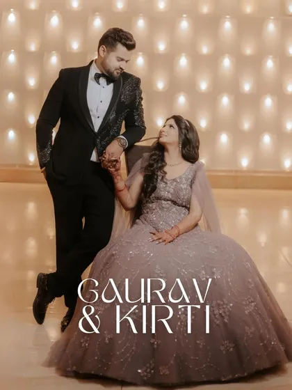 A classic, elegant portrait of Gaurav and Kirti, with the groom seated and the bride standing, their gazes locked in a moment of love.