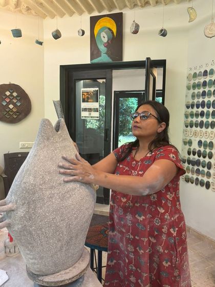 A student working on a large, sculptural vase. Hand-building allows for creating impressive, large-scale forms that make a statement.