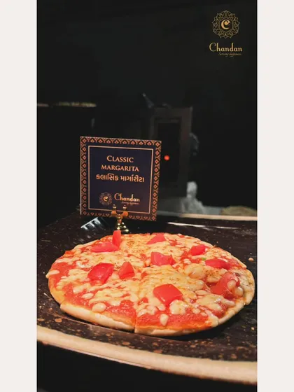 A classic Margherita pizza, fresh from the oven. The menu sign shows that I also provide descriptions in Gujarati, adding a personal touch for local clients.