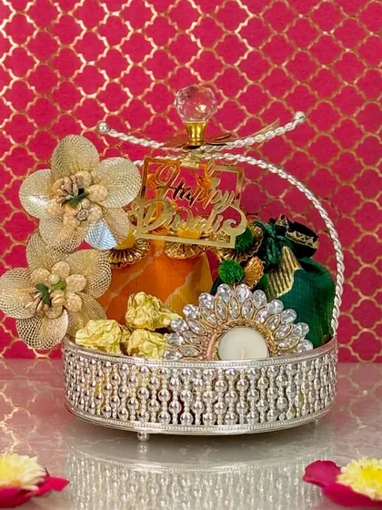 This dazzling silver crystal-top basket is designed to make any celebration sparkle. I fill it with curated dry fruits in colorful potlis and an embellished diya, making it a radiant and memorable gift.