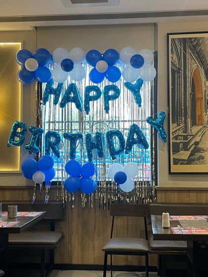 A clear view of the blue and white birthday setup. This type of decoration is versatile and works well for birthdays of all ages.