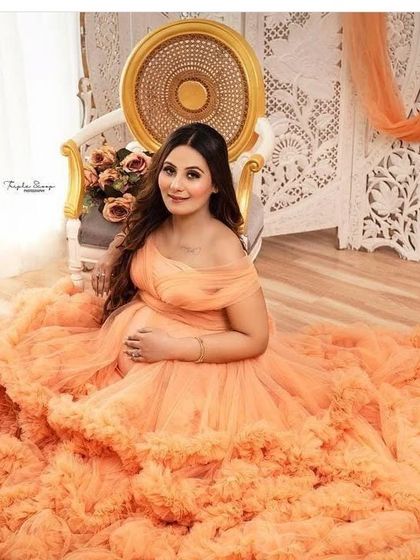 This overhead shot shows the full beauty of the peach ruffled gown's train. The layers of tulle create a stunning texture that fills the frame.