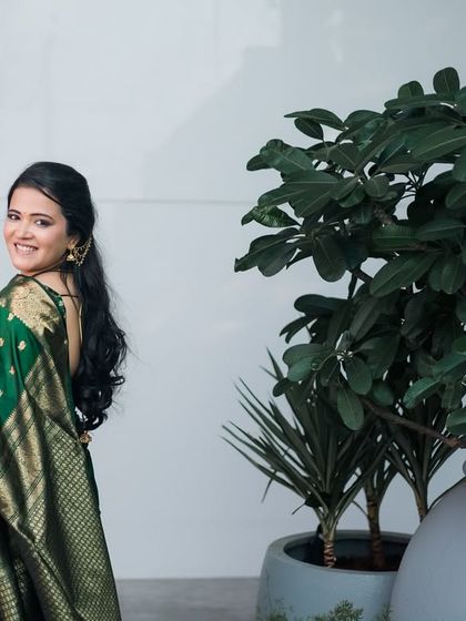 A beautiful solo portrait of the bride in a gorgeous green and gold saree. Her confident smile over her shoulder makes for a stunning shot.