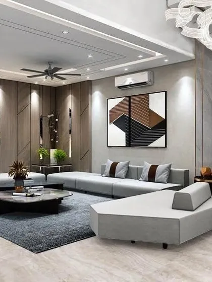 This avant-garde living room features a statement White Panda marble cladded wall behind the TV. The low-profile, modular sofa and dark wood paneling create a modern and dramatic atmosphere.