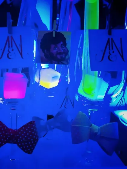 I love adding interactive and fun elements like these glowing ice cubes and custom caricature tags. The neon glow under the blacklight creates a vibrant, club-like atmosphere perfect for a Bollywood sangeet night.