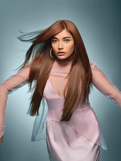 Another dynamic shot for Schwarzkopf, where the makeup enhances the model's features without competing with the hair. The focus is on glowing skin and subtly defined eyes and lips.
