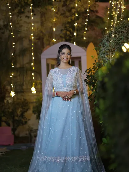 The bride posing in her beautiful blue sangeet outfit. Her smile says it all, she feels as magical as she looks.