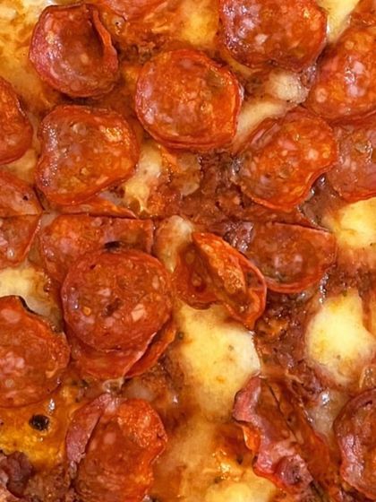 A macro shot of my pepperoni pizza, showing the rich texture of the melted cheese and crispy pepperoni. This is what pizza love looks like up close.