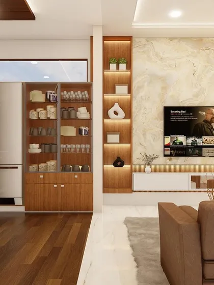 An open-plan living area where the TV unit, featuring a marble-style backdrop and backlit display shelves, is visible from the kitchen, creating a cohesive and social home environment.