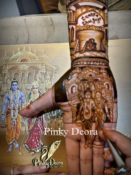 A close-up of the groom's hand, showing the Ram-Sita portrait from their wedding invite. It's a beautiful way to symbolize the foundation of their relationship.
