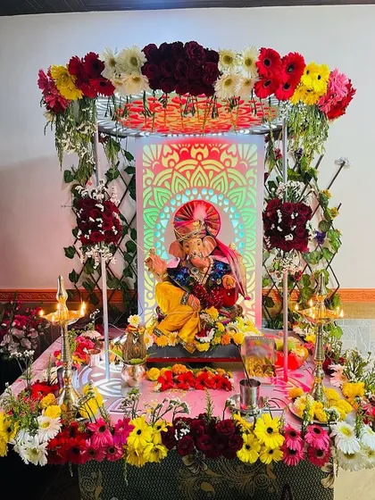 This setup combines traditional elements with a modern touch. I used a vibrant arch of multi-colored gerberas framing a custom backlit panel with a mandala design, creating a unique and radiant focal point for the idol.