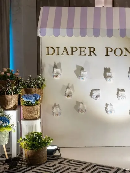 Let the games begin! A custom 'Diaper Pong' station for a Parisian-themed baby shower, providing a fun and interactive activity for guests.