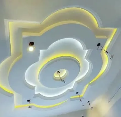 A beautiful floral-patterned ceiling with layered petals. The lighting from behind each layer creates a soft, diffused glow, making it look like a blooming flower.