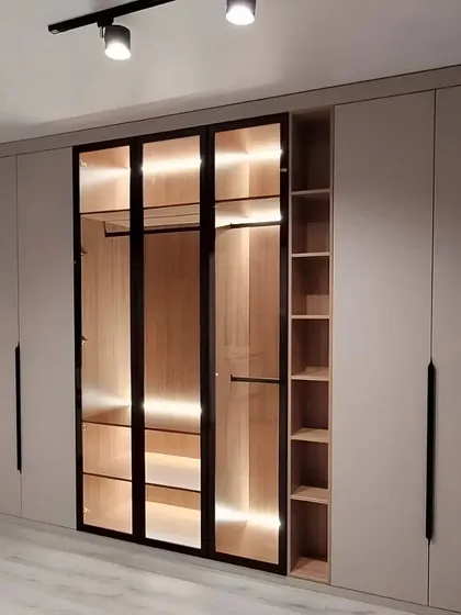 Another view of this stunning wardrobe, highlighting the sleek black handles and the warm glow of the integrated lighting. The design is modern, beautiful, and built to elevate your living space.