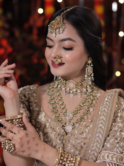 A closer look at the Diwali-themed makeup. The soft gold tones on the eyes and the beautiful pastel pink jewelry create a look that is both festive and elegant.