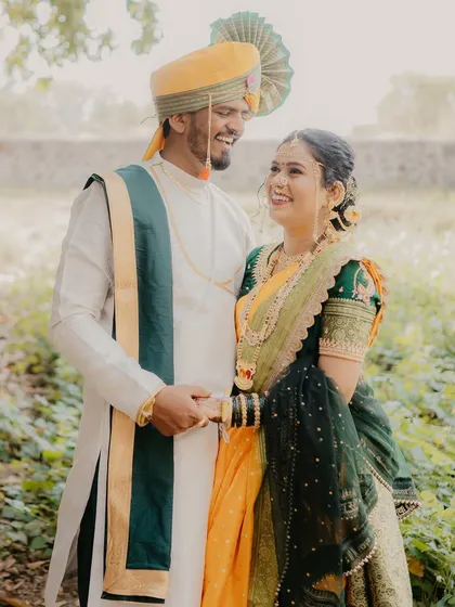 A happy, relaxed portrait of the couple holding hands and smiling. This image captures the easy, joyful nature of their relationship during their outdoor shoot.