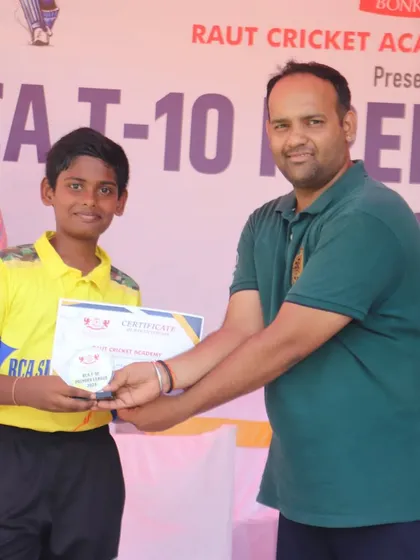 A player from the RCA Super Kings receiving his certificate and award.