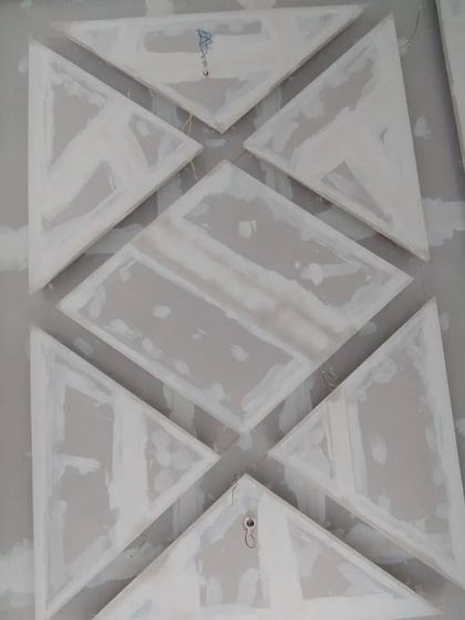 A close-up of the geometric POP ceiling pattern during the application process.