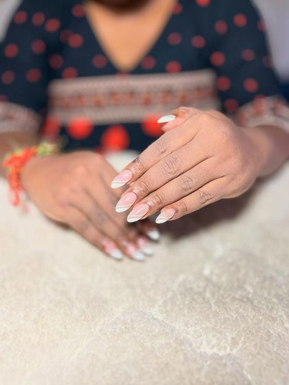 A simple and chic design with a sheer nude base and delicate white line art for a minimalist look.