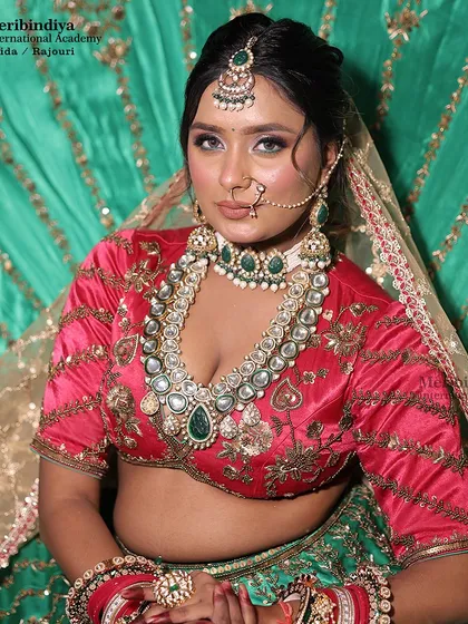 This look demonstrates how to work with a dual-color palette. The makeup complements both the pink blouse and green lehenga, creating a balanced look.