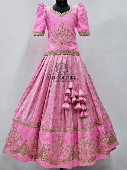An incredibly detailed all-pink Banarasi lehenga. The blouse and skirt feature heavy maggam work embroidery for a very grand look.