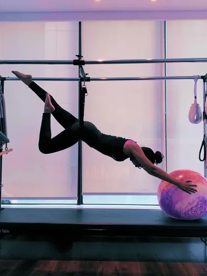 Another beautiful variation on the Cadillac, showcasing the artistry and control that Pilates develops. Every movement is deliberate and graceful.
